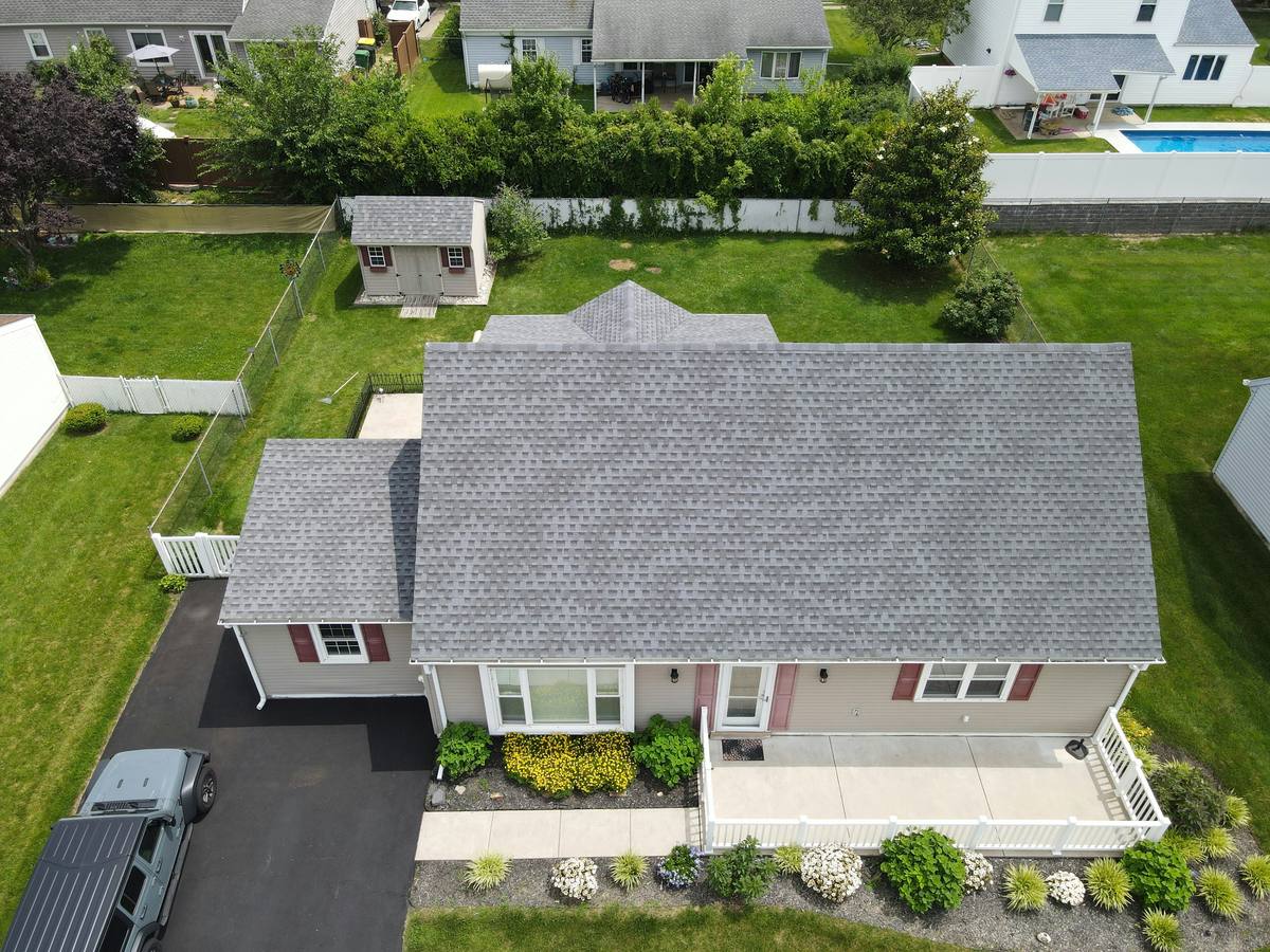 Aerial view of a home with a new gray shingle roof