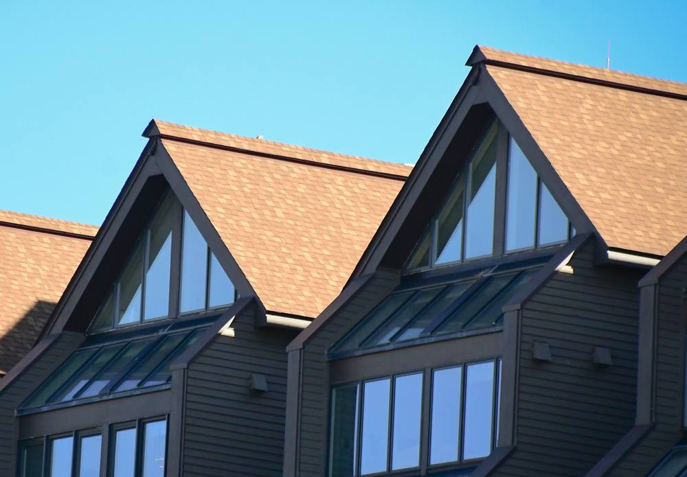New tan shingle roof over gabled dormers